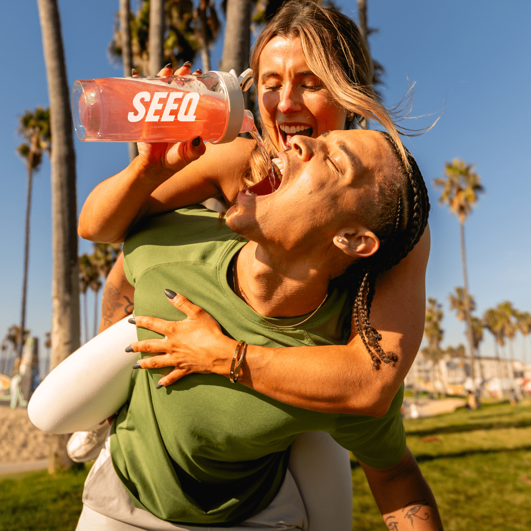 Clear Protein Fruit Punch – SEEQ, Active Couple Having Fun Outdoors With A SEEQ Shaker