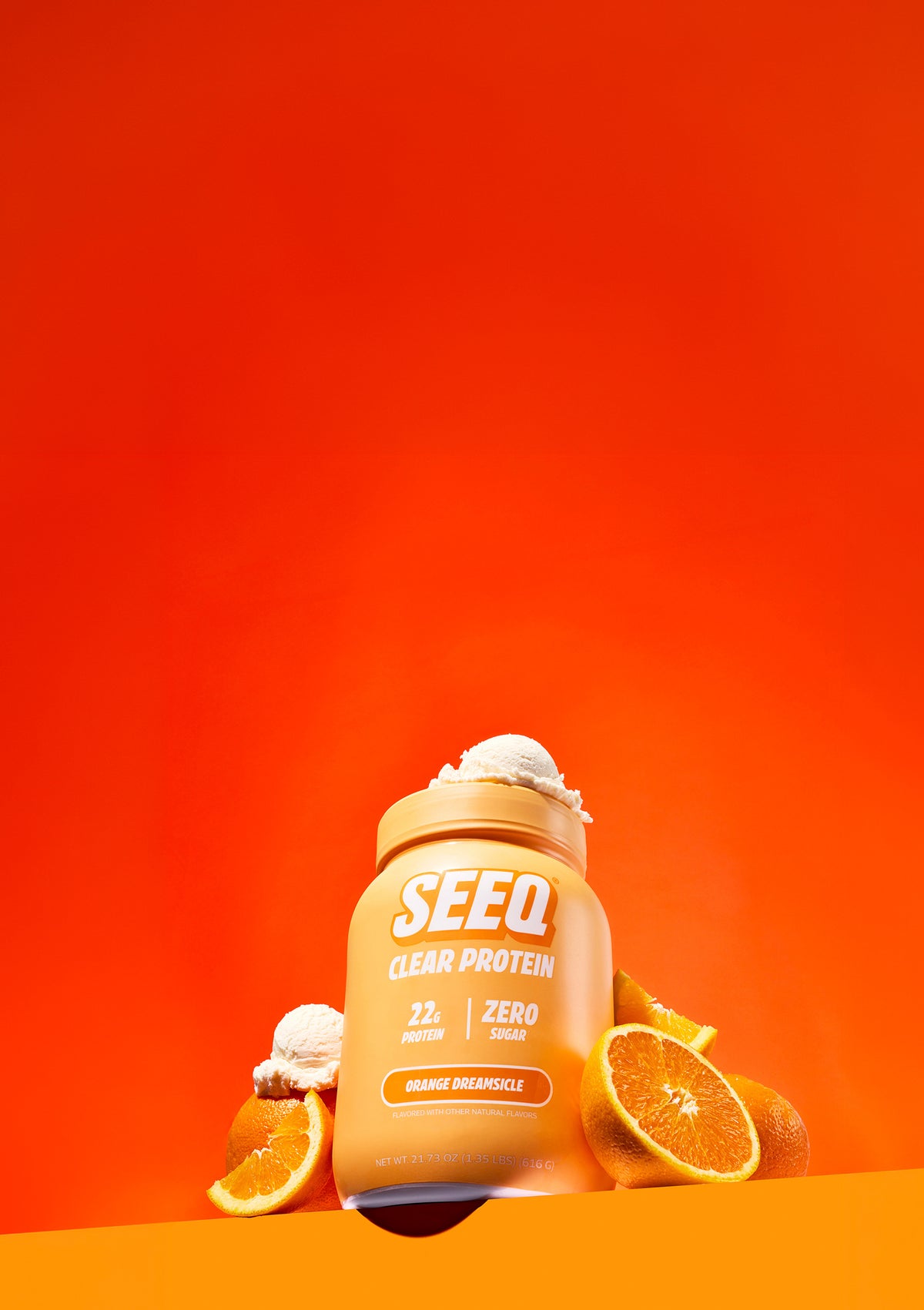 SEEQ protein powder jar with oranges and ice cream on an orange background